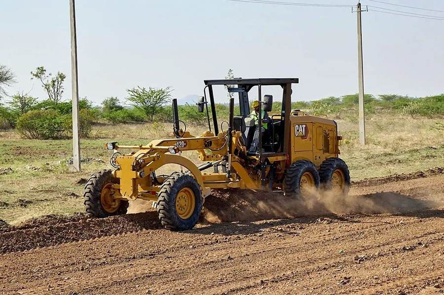Motor grader shaping a gravel road