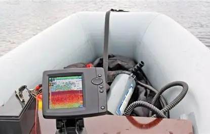 Echo sounder display and transducer kit set up in a survey boat.
