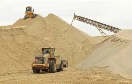 Wheel loader working a sand stockpile.