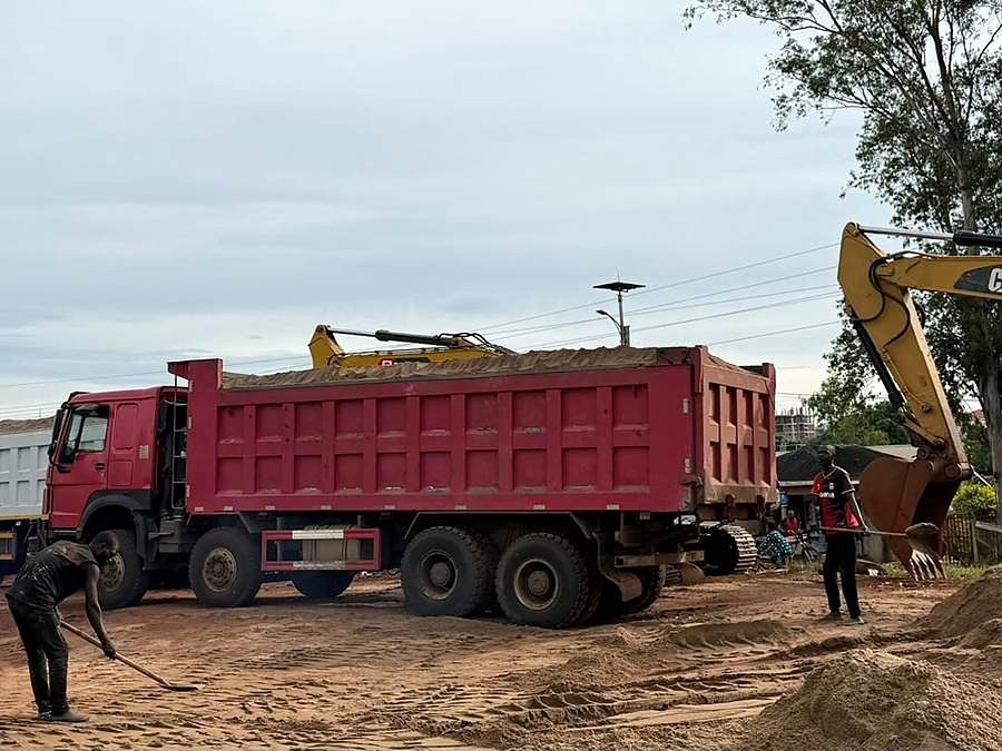 Tipper truck being loaded beside an excavator.